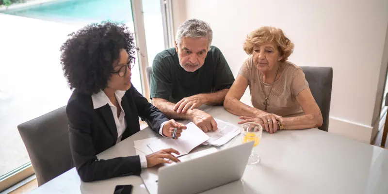 Financial advisor helping a senior couple at home