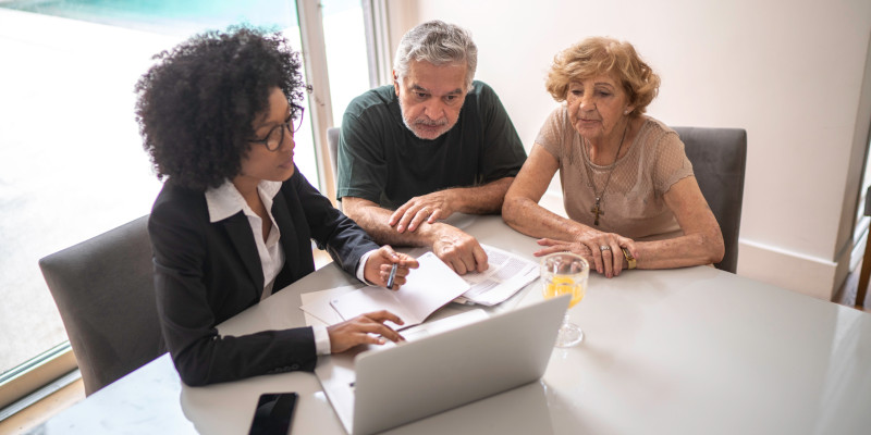 Financial advisor helping a senior couple at home