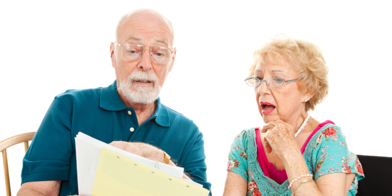 An old man and woman looking at documents