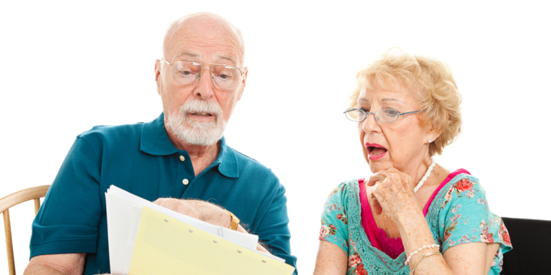 Two elders reading documents wearing spectacles